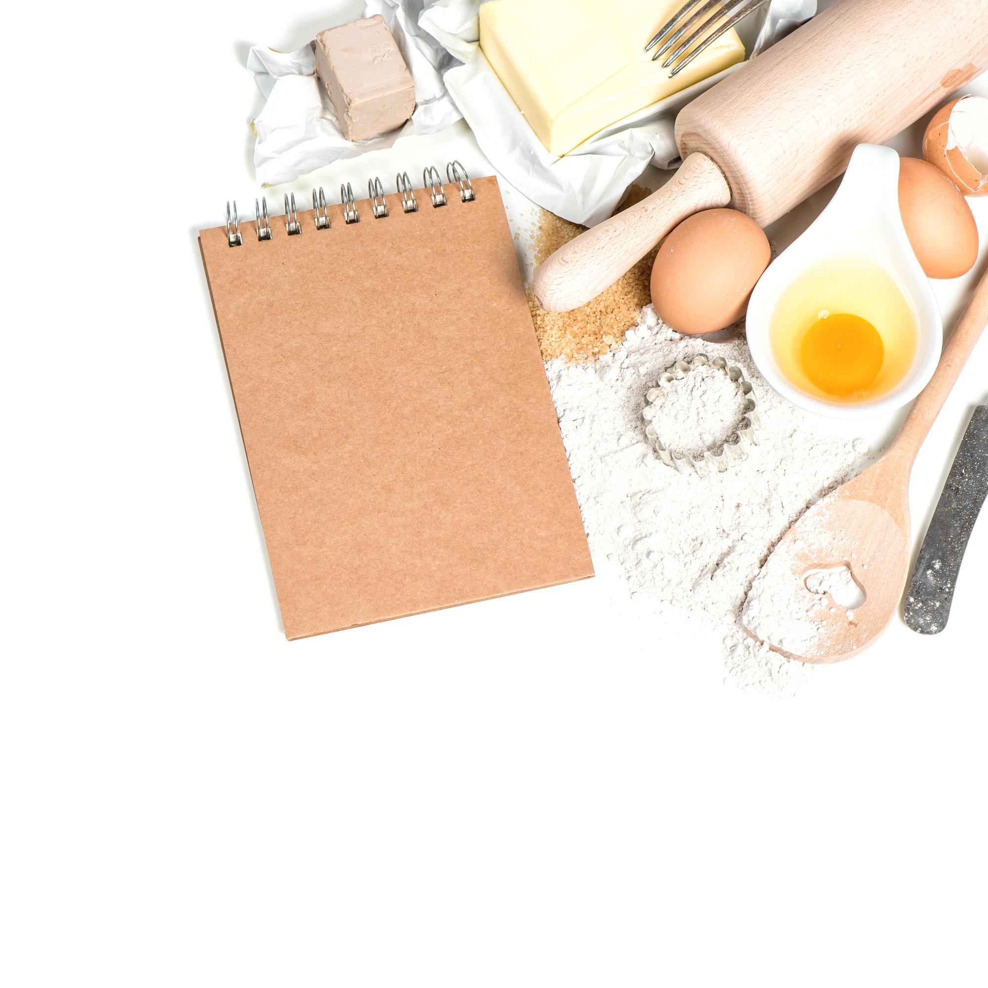 workshop table with cooking tools and open notebook
